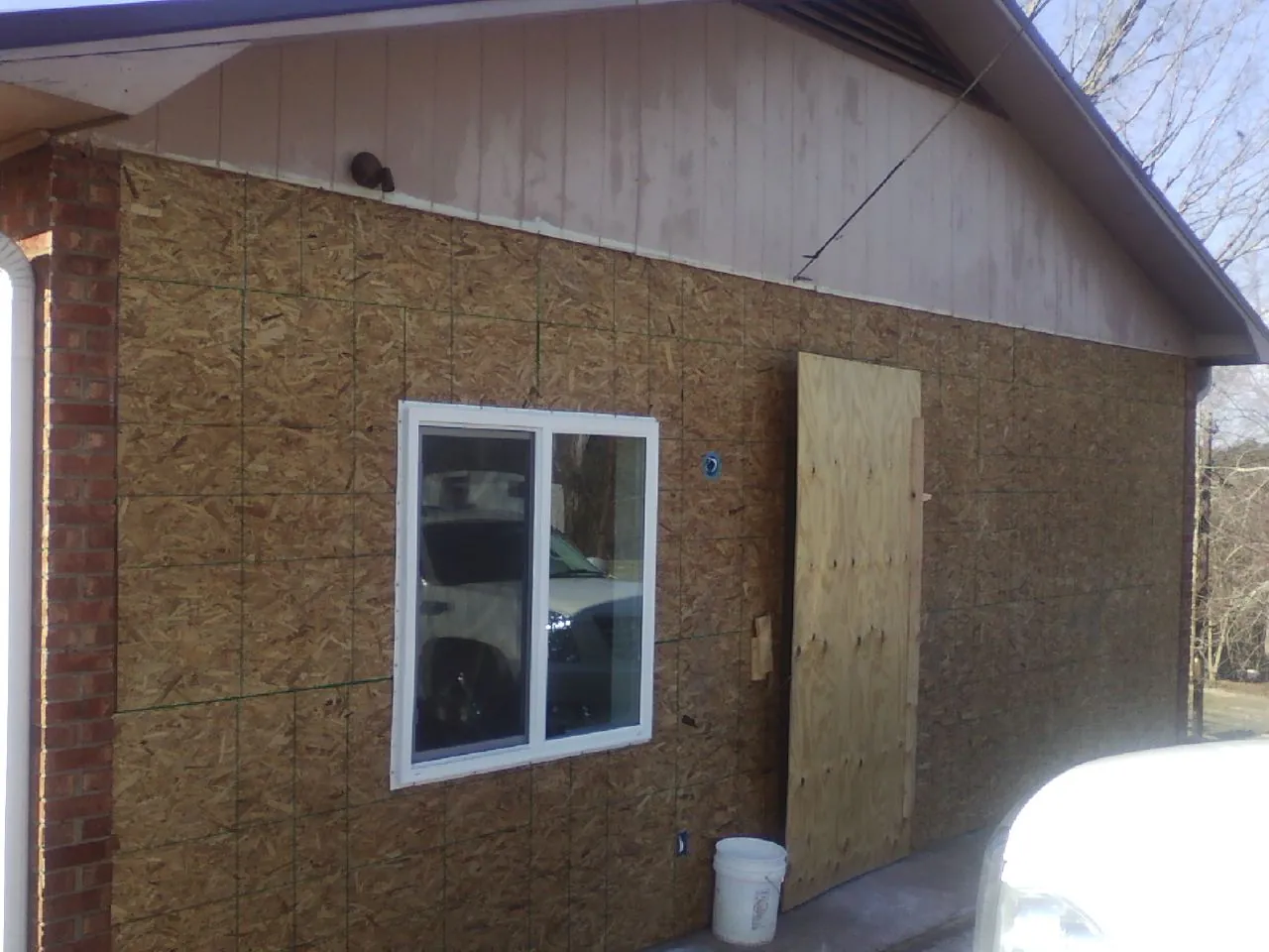OSB sheathing on a garage addition wall before siding in Fulton